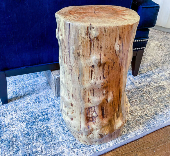 Tree stump side table next to sofa